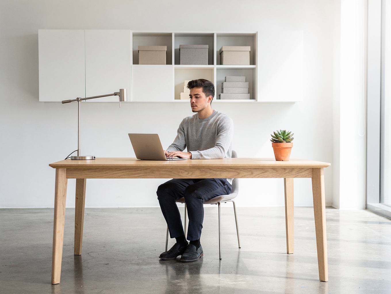Solo creator working efficiently in a clean, modern home office